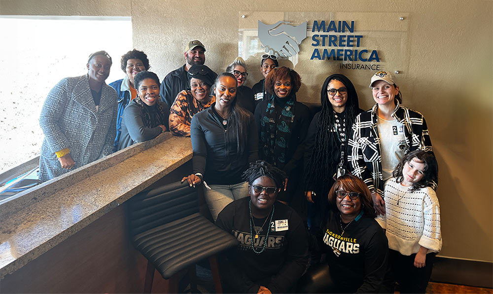 Group photo in front of Main Street America logo